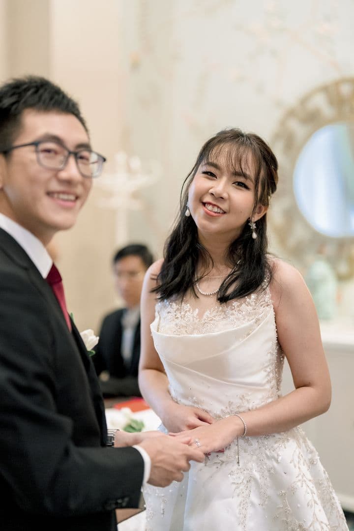 Shun smiling as Toe holds her hand with the ring