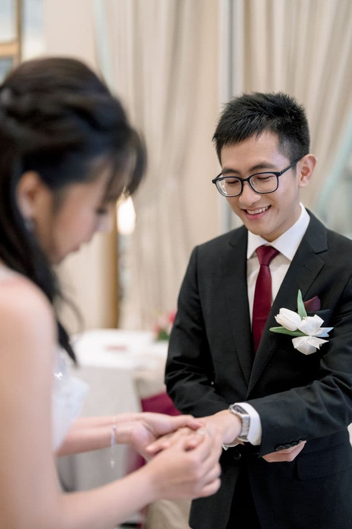 Toe smiling as Shun places a ring on his finger